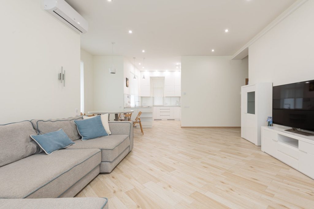 Spacious and modern living room interior with elegant furniture and bright lighting.